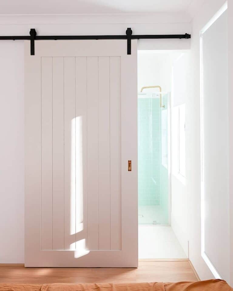 All-white Room Enhanced by a Paneled Door