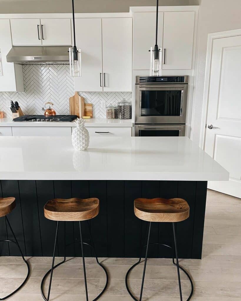 Clean Kitchen With White Countertop and Wooden Stools