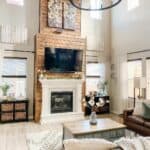 Elevated Wood Fireplace Extends To Vaulted Ceilings