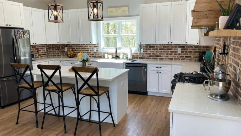 Farmhouse Kitchen With Exposed Brick Wall and White Island