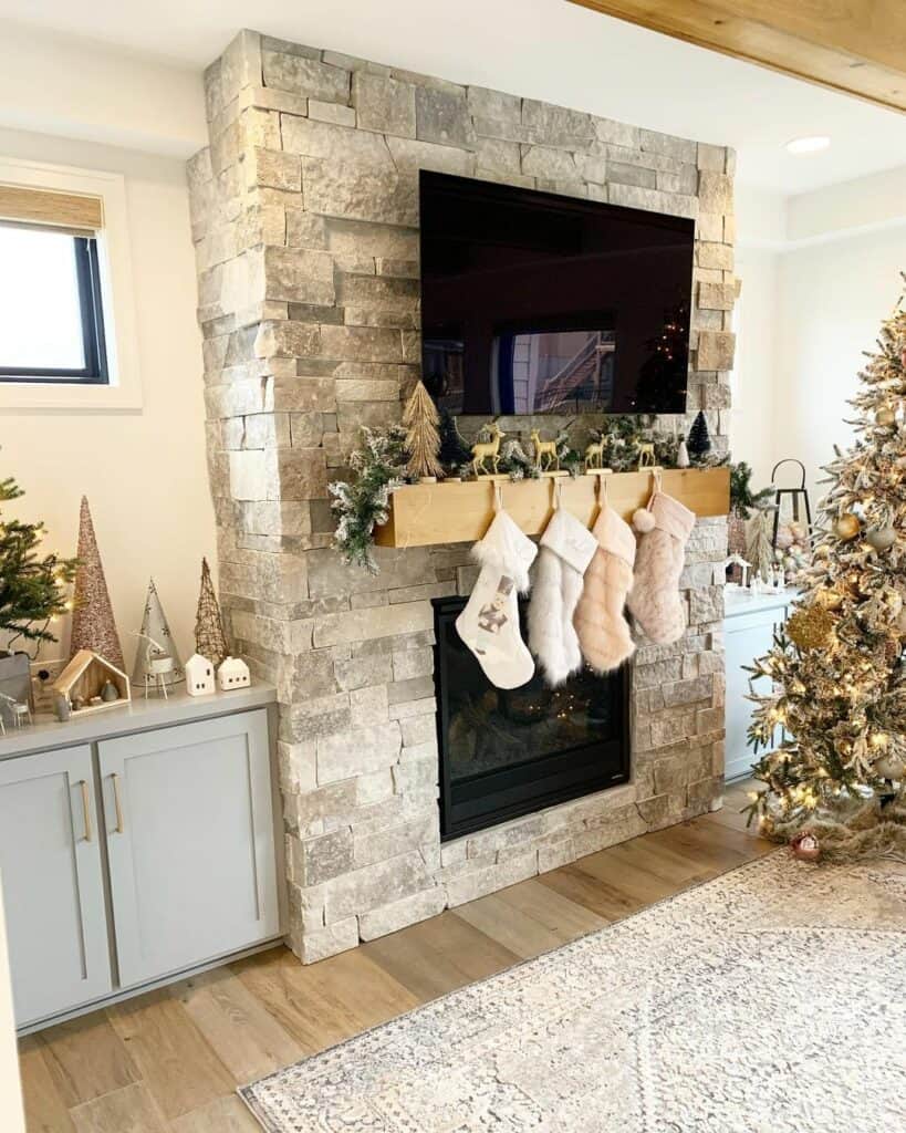 Gray Stone Fireplace With Christmas Fur Stockings