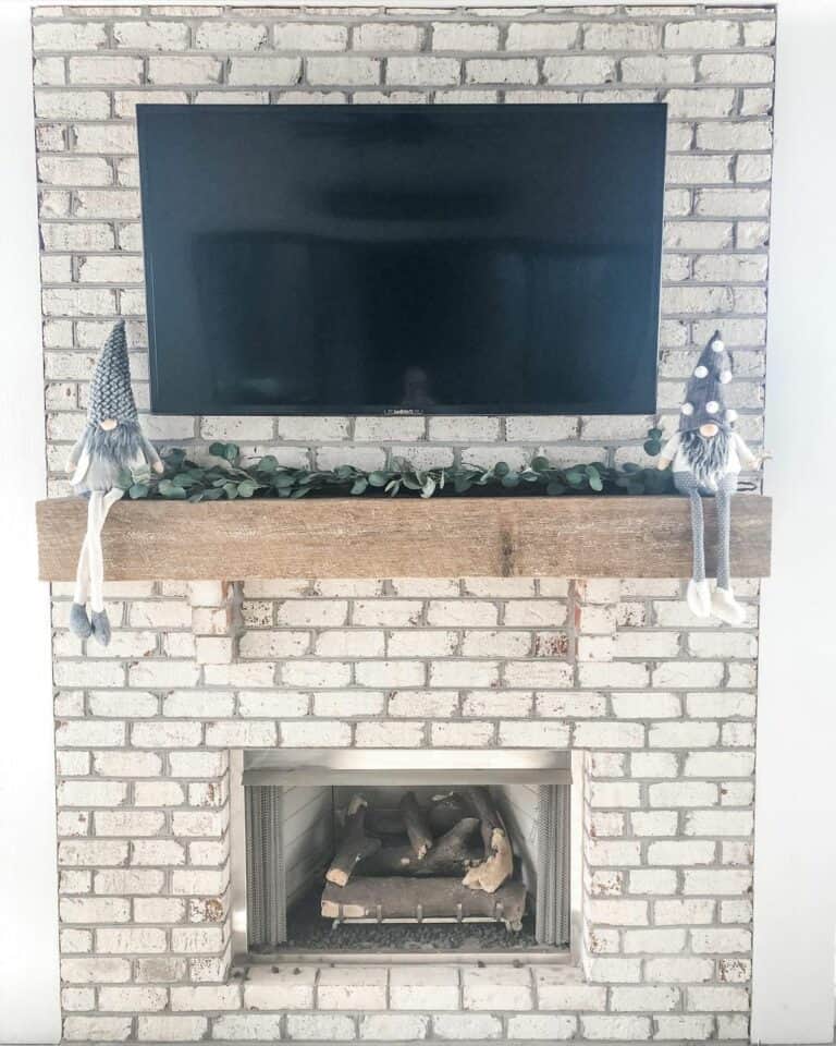 Light Brick Outdoor Fireplace With Mounted TV
