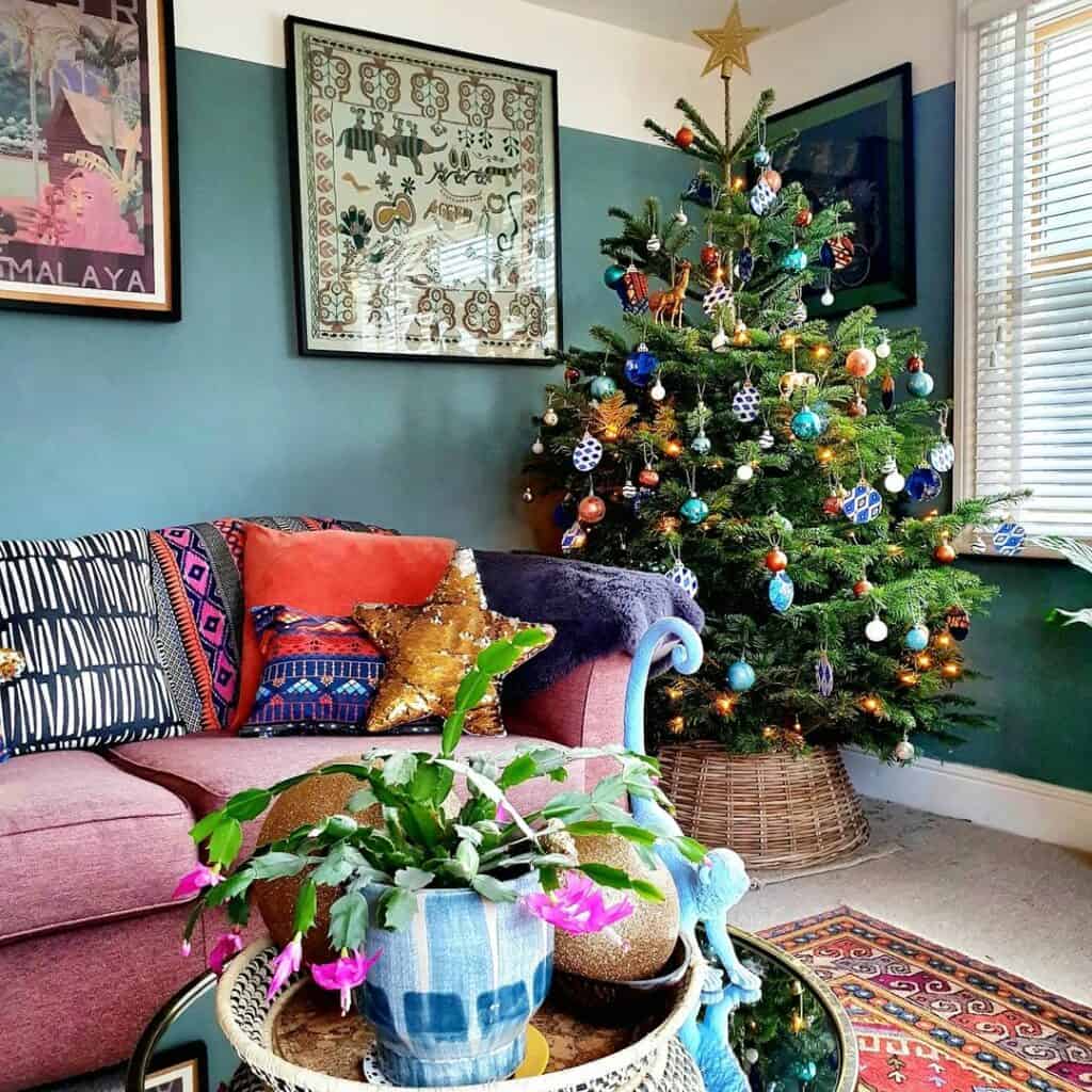 Living Room Christmas Décor With Teal Walls and Pink Sofa