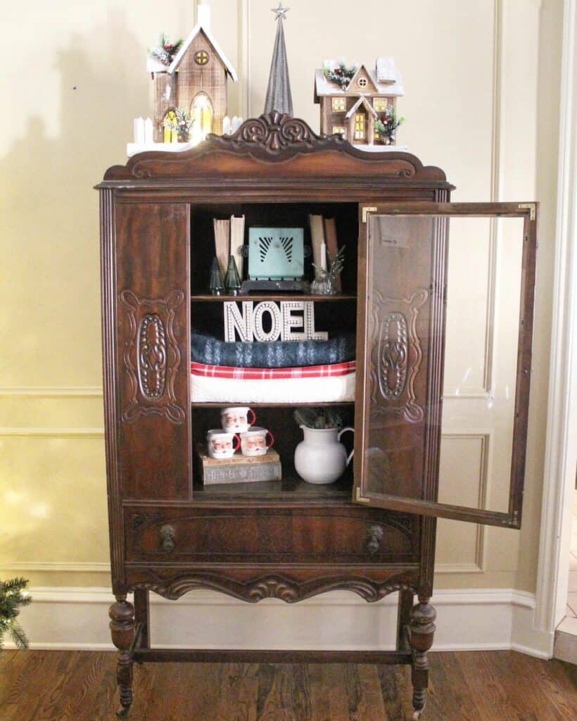 Mini Christmas Village on Top of Rustic Cabinet