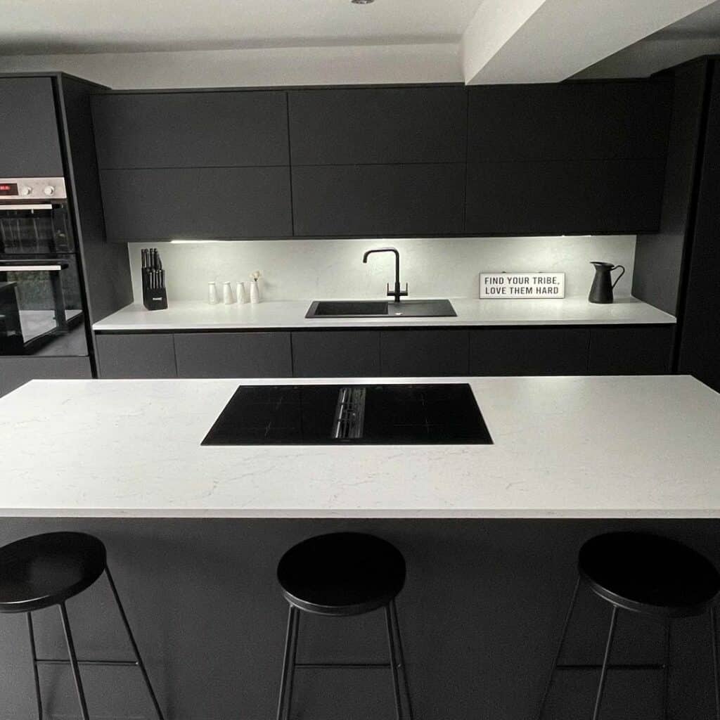 Modern Kitchen With Black Cabinets and White Island
