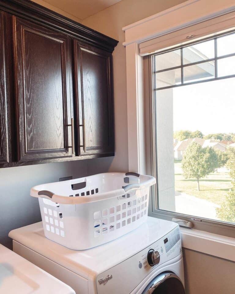 Neutral Laundry Room With Dark Wood Cabinets