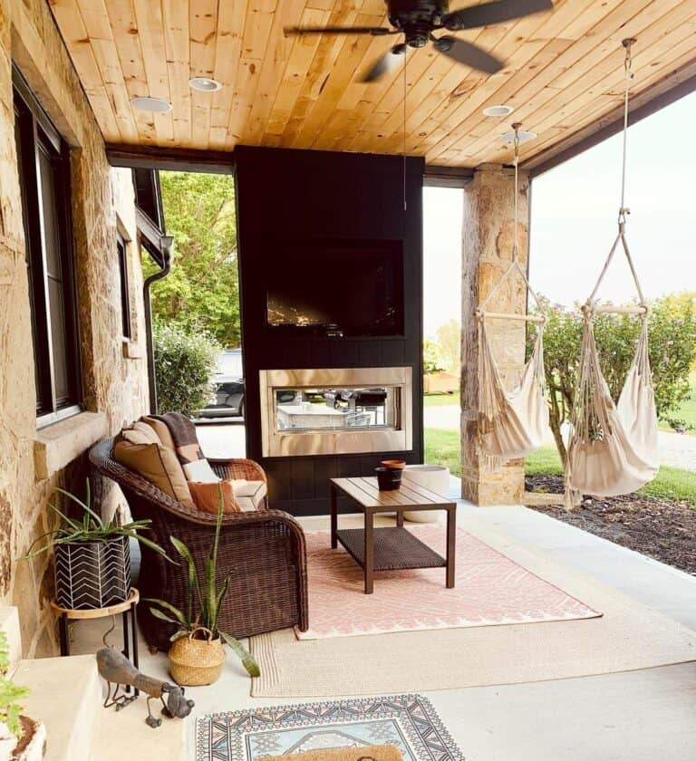 Patio With Exposed Wood Ceiling and Jet-black Fireplace