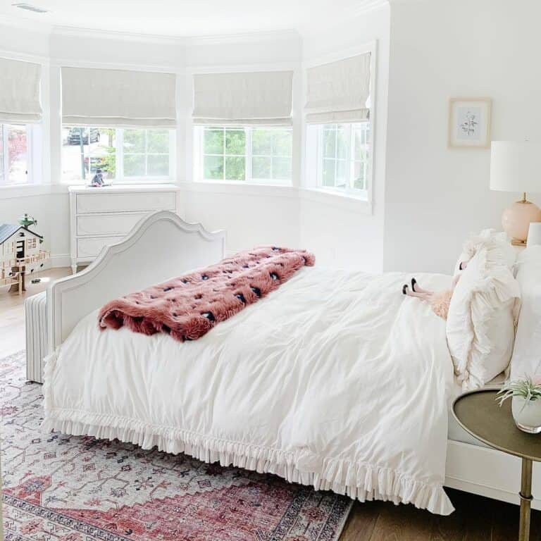White Farmhouse Girl's Bedroom Décor With Pink Blanket