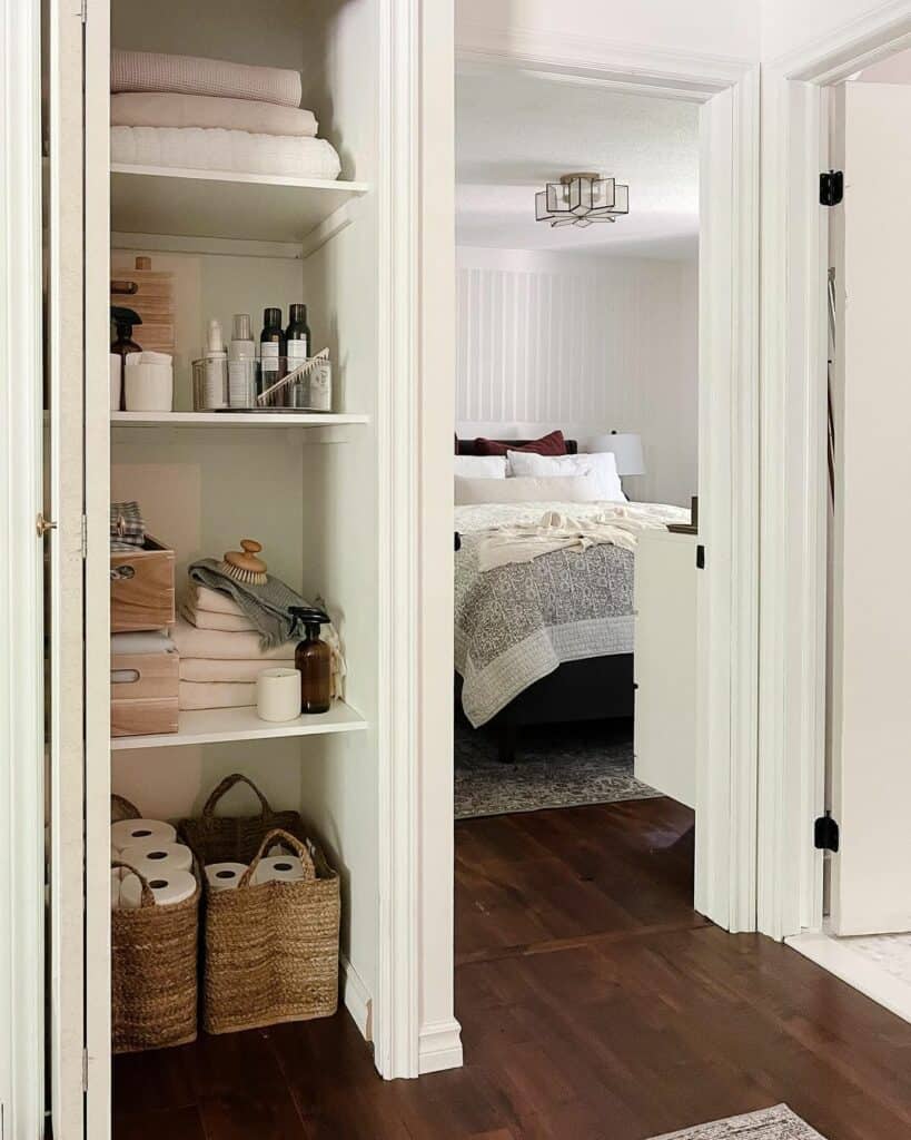 White Linen Closet With Rattan Basket and Skincare Products