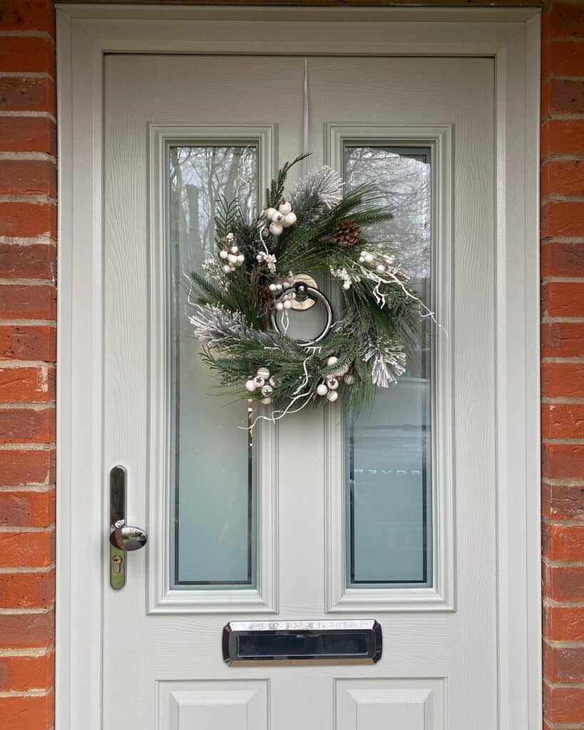 Winter Door Wreath With White Ornaments and Pine Cones