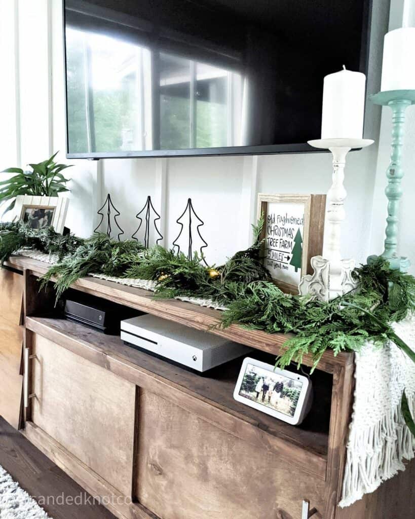 Wooden Entertainment Console With Pine Garland