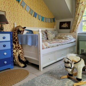 Yellow Accent Wall and Blue Dresser in Bedroom