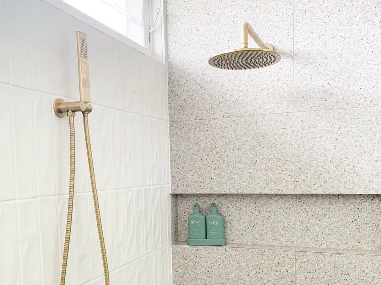 Textured Vertical Accent Tile in Shower With Gold Accents