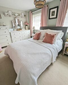 Bed in Front of Pink Curtains