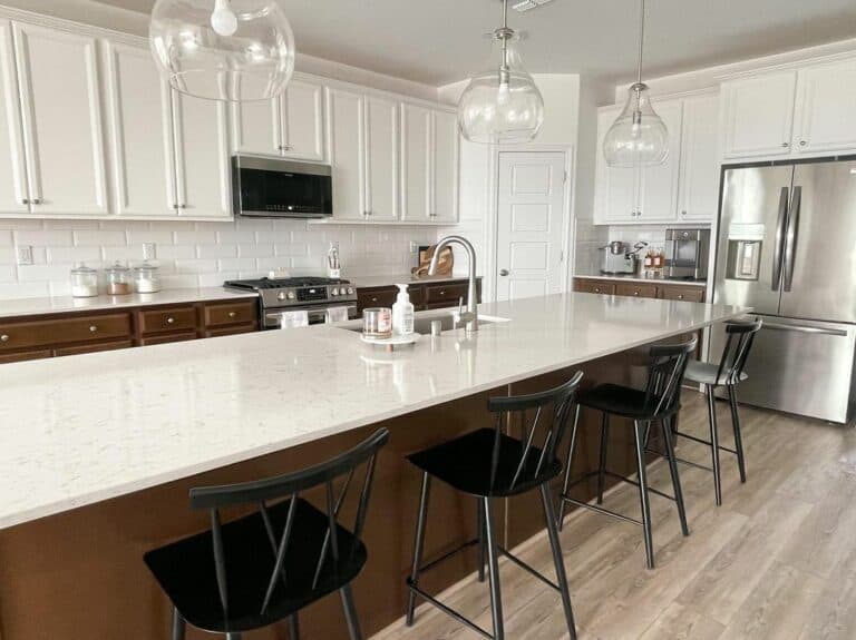 Brown and White Kitchen Island With 4 Black Seats