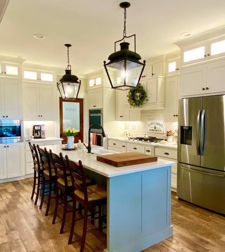 Frosted Pantry Door Between White Shaker Cabinets
