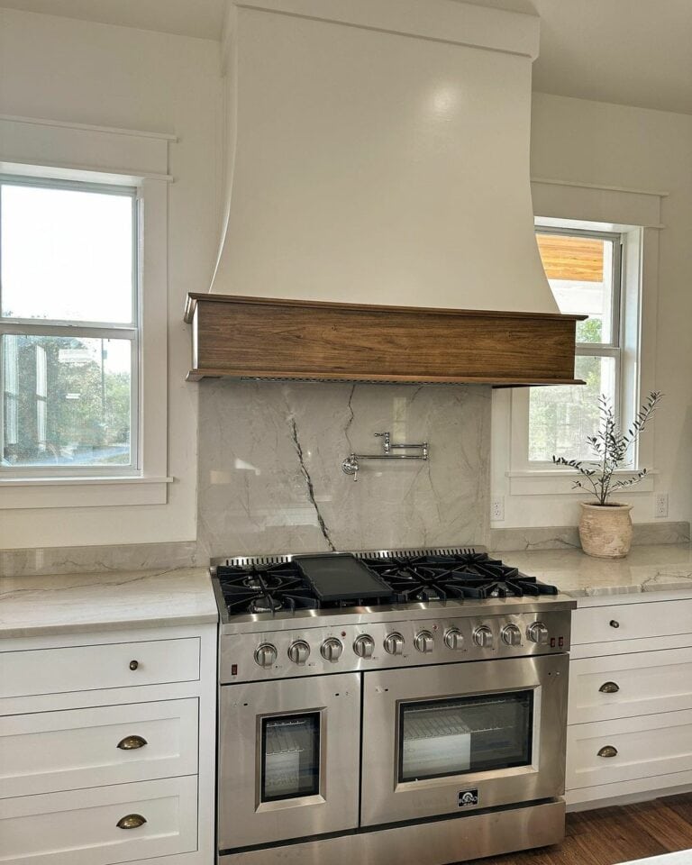 Prominent Wood Trimmed Hood With Marble Backsplash