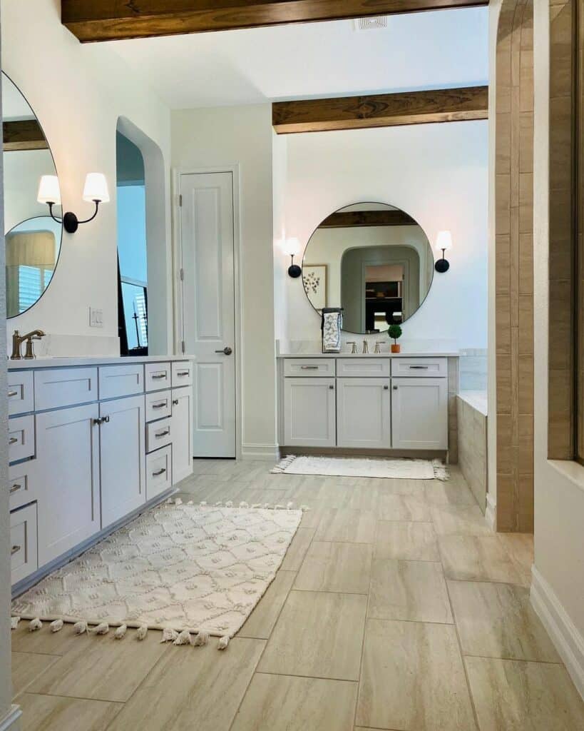 Separate Vanities With Circular Mirrors and Wallchieres